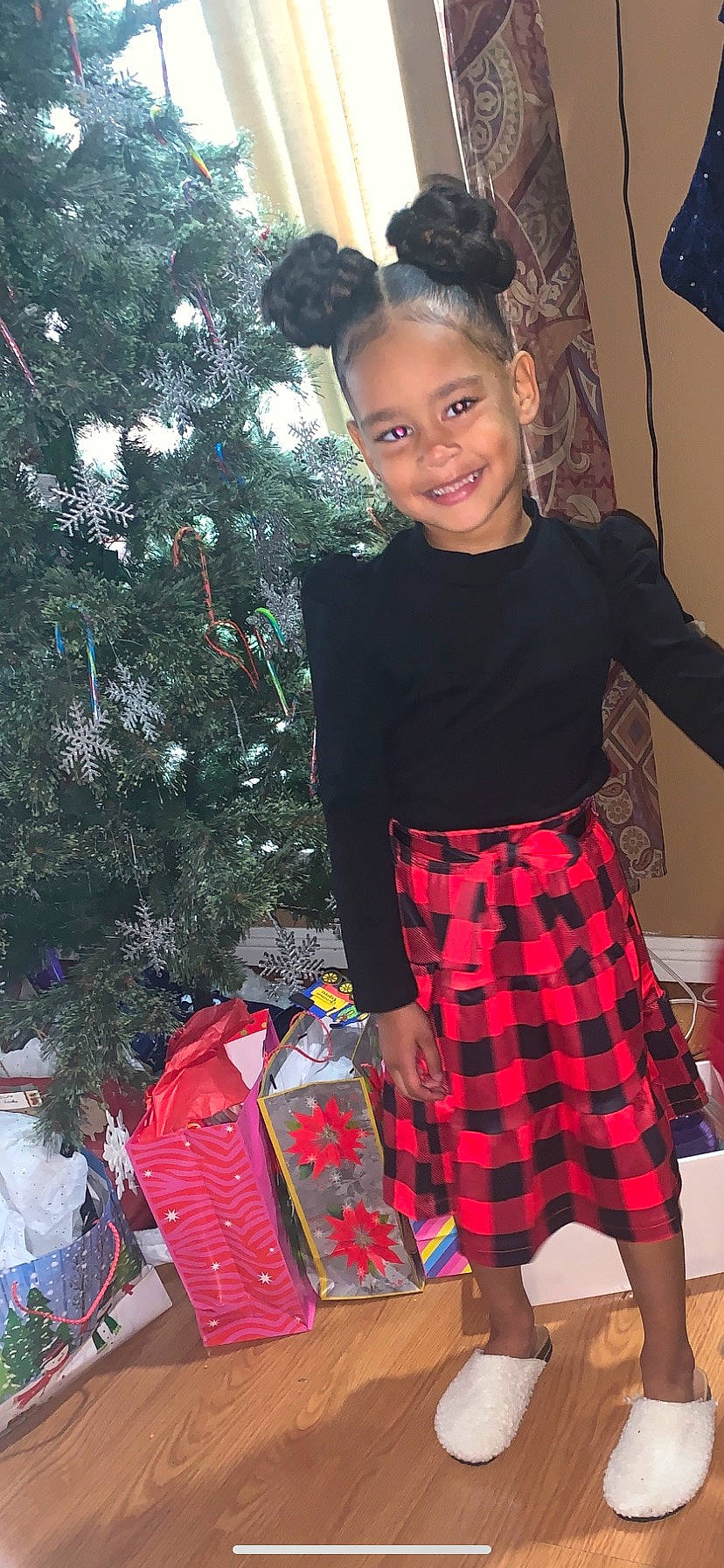 Karli is registered to the contest to win money with this photo: christmas_decoration, christmas_ornament, christmas_tree, event, fashion_design, fun, holiday, holiday_ornament, joy, knee, ornament, pattern, person, plaid, sleeve, standing, tartan, thigh, toddler, tree