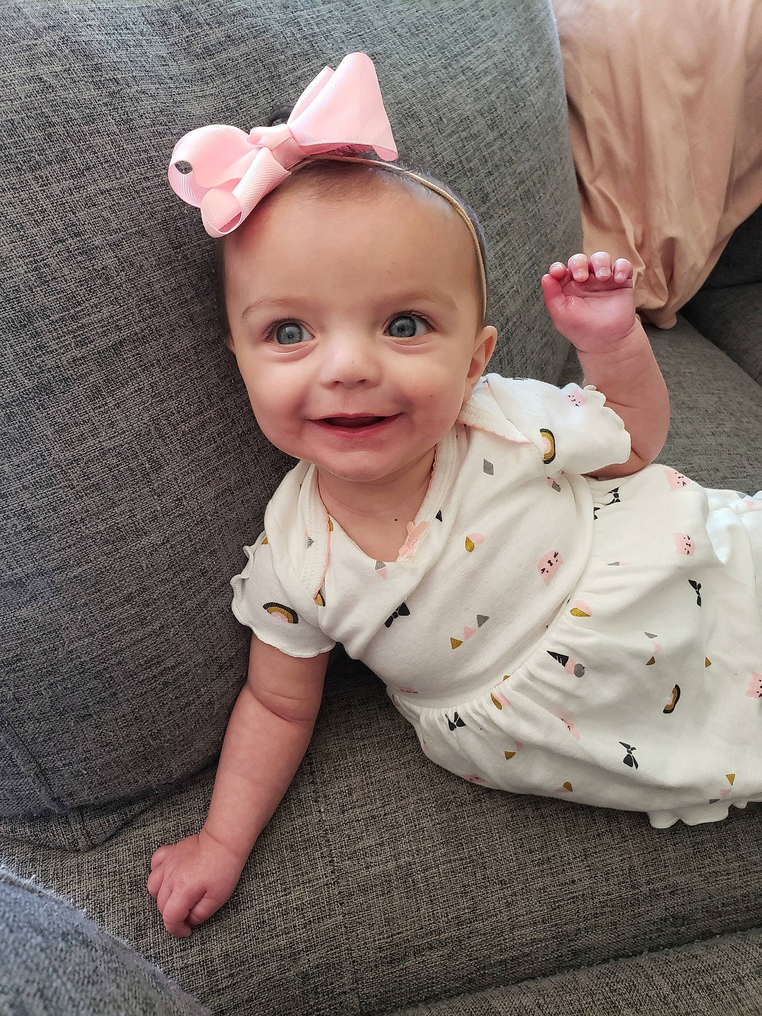 Abigail is registered to the contest to win money with this photo: baby, baby_toddler_clothing, cheek, child, design, dress, ear, face, hair_accessory, head, headgear, joy, outerwear, pattern, person, pink, sitting, skin, sleeve, toddler