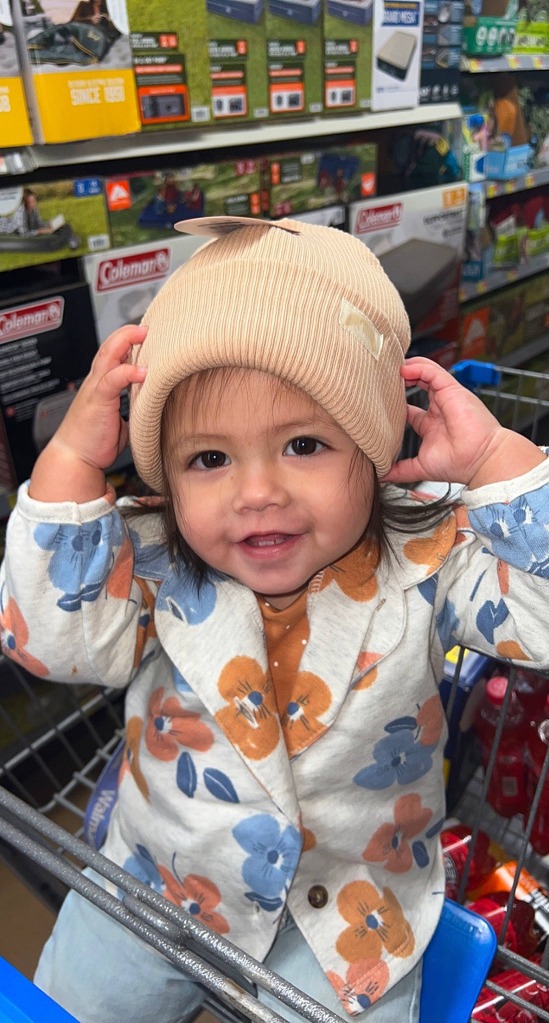 Amalia is registered to the contest to win money with this photo: baby, baby_toddler_clothing, beanie, cap, cheek, child, city, eye, facial_expression, fashion_accessory, fun, happy, headwear, knit_cap, market, person, product, retail, skin, sleeve