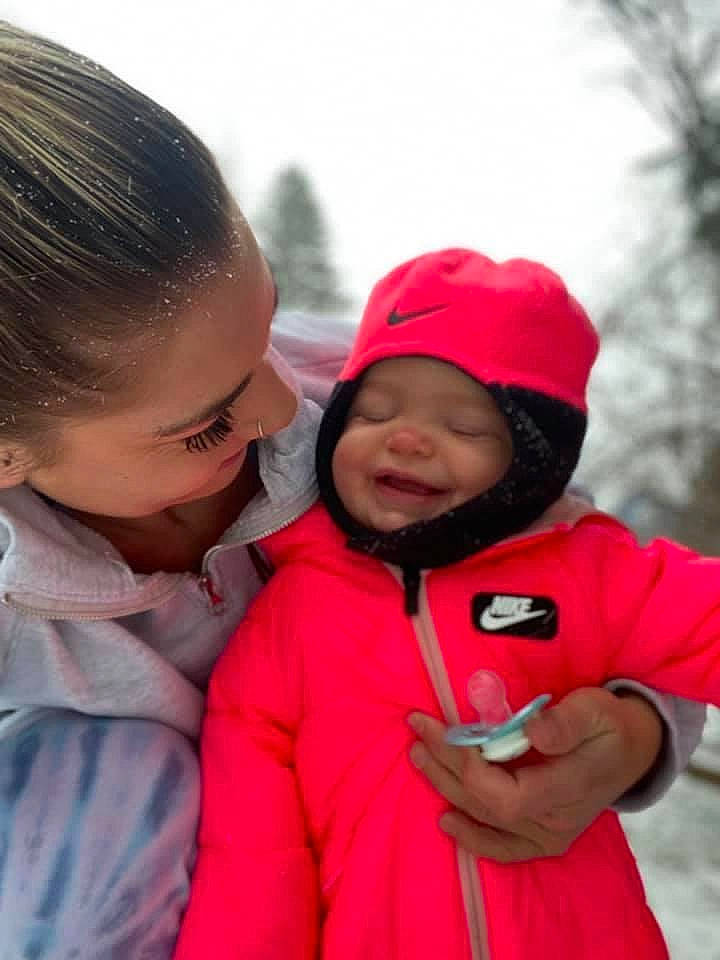 Laylin is registered to the contest to win money with this photo: baby_toddler_clothing, cap, cheek, child, clothing, facial_expression, happy, head, headwear, hood, human, jacket, lip, mammal, outerwear, person, pink, red, skin, sleeve