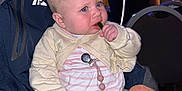 Oakleigh Mae is registered to the contest to win money with this photo: baby, child, infant, person, sitting, clothing, hand, face, blue_eyes, pacifier_clip, indoor, adult_hand, chair, table, light, room, blurred_background, striped_shirt, knitwear, curious_expression