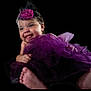 baby, smiling, purple_tutu, headband, flower, portrait, infant, cute, happy, child, foot, black_background, clothing, tulle, cheerful, face, person, studio, cute_expression, closeup