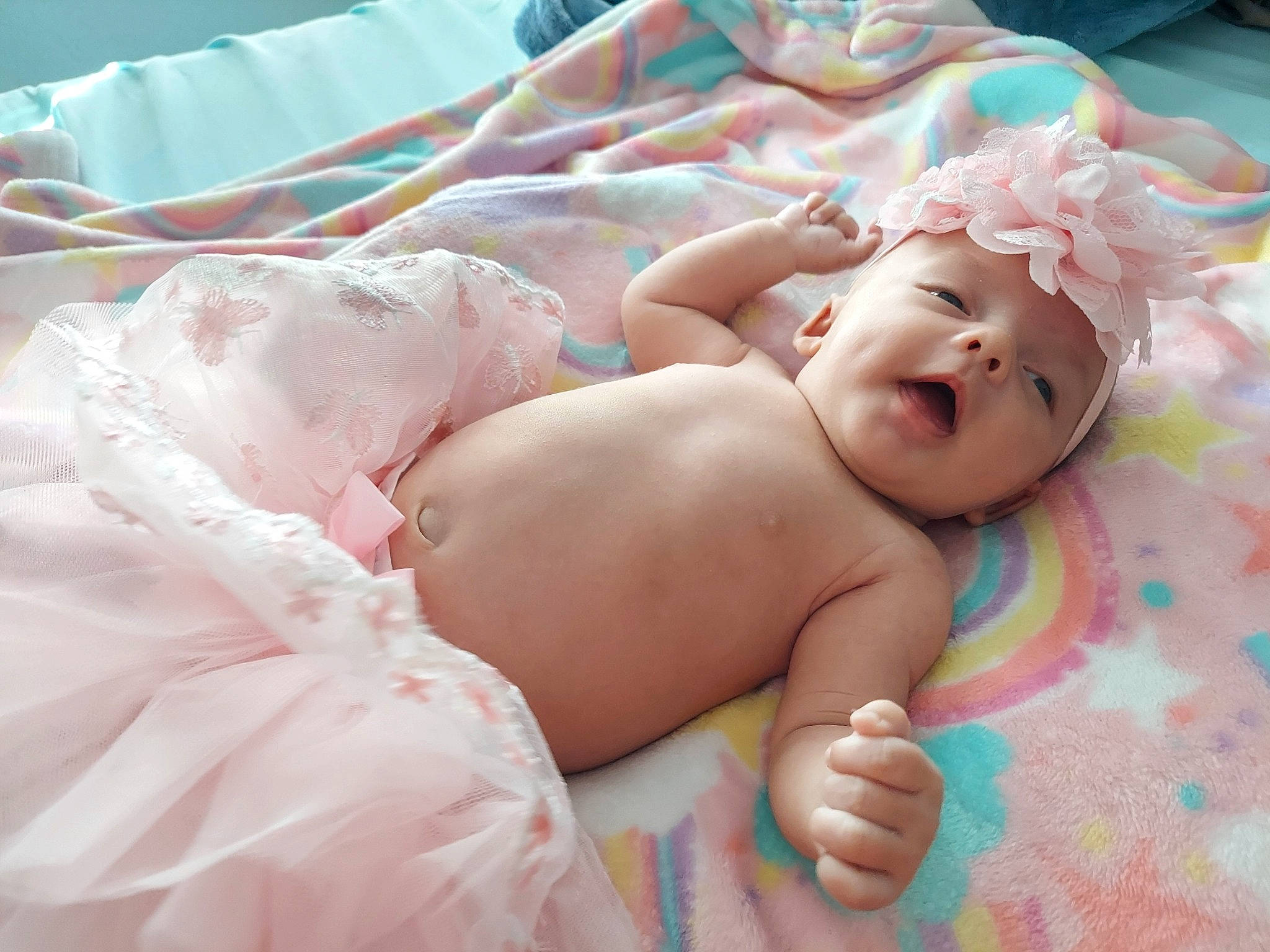 Cadence is registered to the contest to win money with this photo: abdomen, baby, baby_toddler_clothing, bedding, chest, child, comfort, diaper, event, finger, fun, happy, hat, headwear, human_leg, linens, person, pink, room, skin
