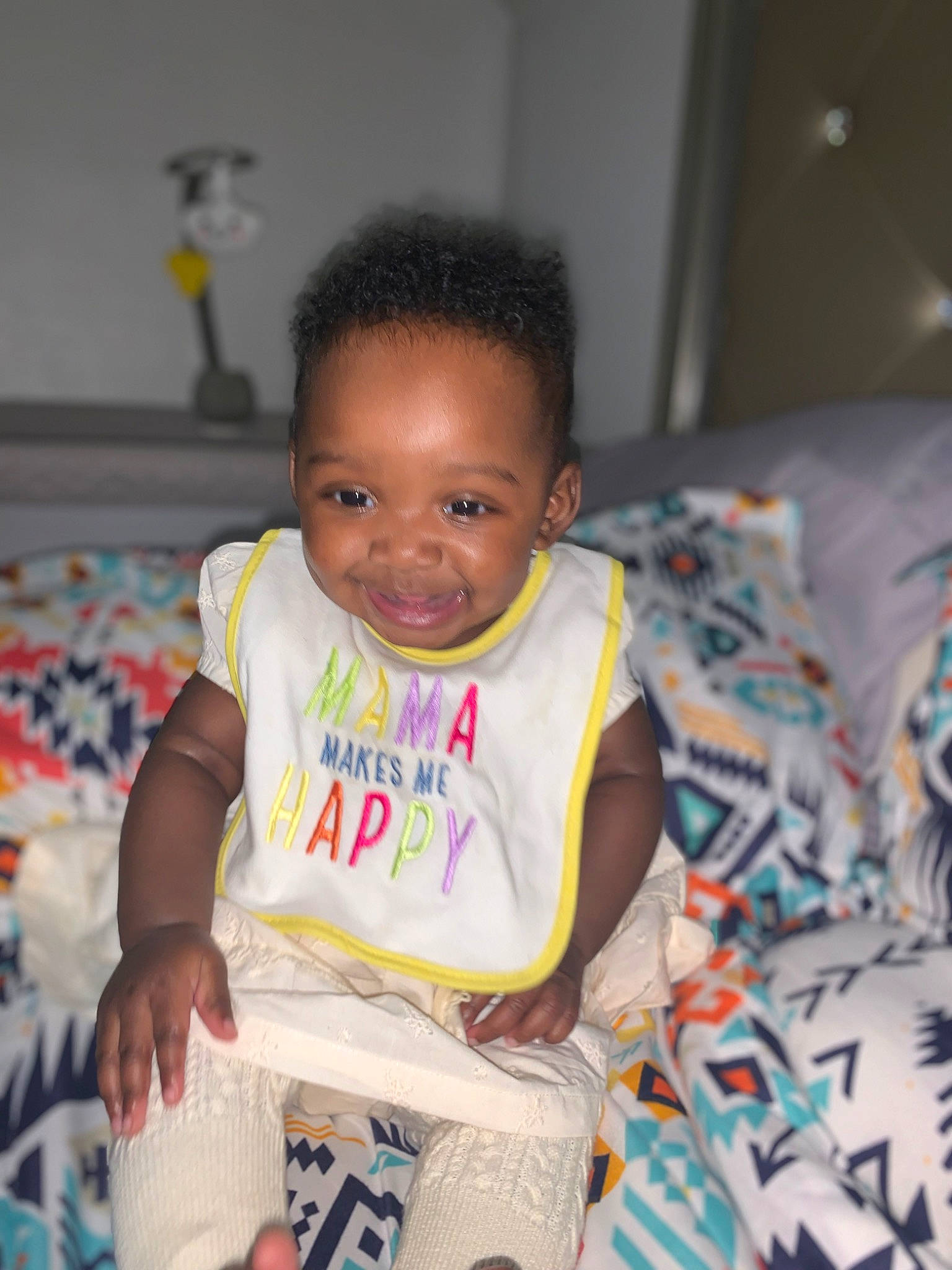 Lailani is registered to the contest to win money with this photo: arm, baby, baby_products, baby_toddler_clothing, cheek, child, eye, face, facial_expression, flooring, fun, hairstyle, happy, head, joy, person, play, room, sitting, smile