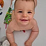 baby, bed, child, crib, cute, diaper, expression, face, furniture, hands, happy, head, indoors, infant, person, play, skin, smiling, toys, young