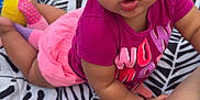 Zariyah joined the competition — help win amazing prizes! baby, blanket, child, crawling, curly_hair, cute, earrings, expression, face, grass, hand, leg, magenta_shirt, outdoor, pattern, person, pink_shorts, playing, summer, toy