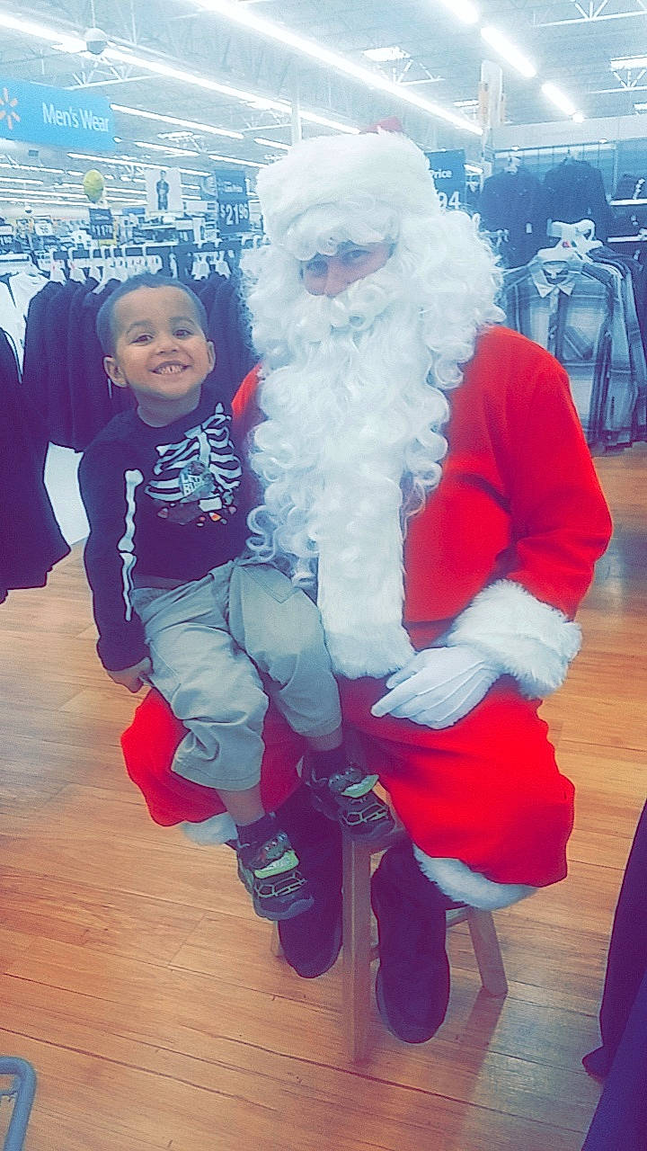 Zalen is registered to the contest to win money with this photo: blue, child, christmas, event, fictional_character, fun, girl, holiday, joy, lap, person, product, red, santa_claus, toddler, winter