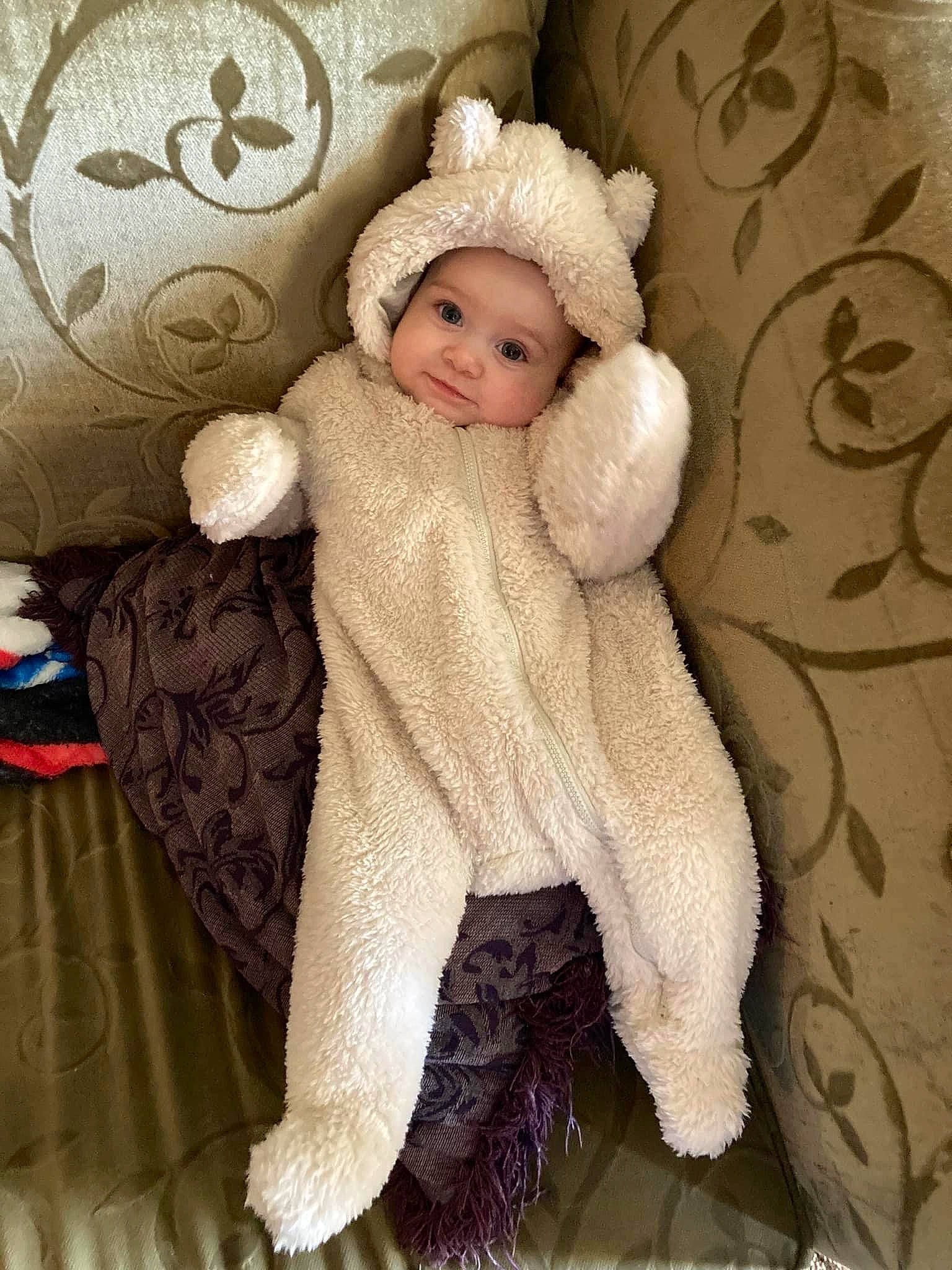Jupiter is registered to the contest to win money with this photo: baby, baby_toddler_clothing, cap, child, comfort, costume_hat, doll, fashion_accessory, fawn, fur, fur_clothing, headgear, headwear, linens, pattern, person, sleeve, stuffed_toy, toddler, wood