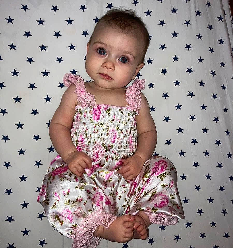 Jupiter joined the competition — help win amazing prizes! baby_toddler_clothing, child, day_dress, design, dress, face, facial_expression, happy, linens, magenta, one_piece_garment, pattern, person, pink, purple, skin, sleeve, smile, toddler, violet