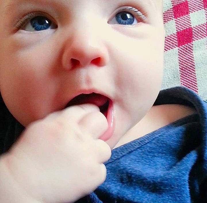 Orion is registered to the contest to win money with this photo: cheek, child, chin, close_up, finger, girl, hand, infant, jaw, lip, mouth, nose, person, smile, toddler, tongue, tooth, yawn