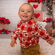 Greyson is registered to the contest to win money with this photo: toddler, child, smiling, red_shirt, heart_pattern, crawling, carpet, valentine, roses, flowers, teddy_bear, wooden_crates, decorations, indoor, happy, cute, portrait, baby, festive, background