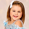 child, smiling, girl, portrait, dress, blue_dress, bow, hair_accessory, happy, cute, face, childhood, fashion, sequins, sparkle, studio, photography, innocence, young, beauty