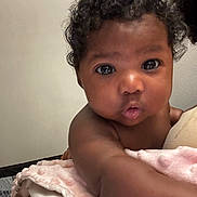 Butterfly joined the competition — help win amazing prizes! baby, infant, curly_hair, blanket, soft_texture, reaching_out, close_up, skin, face, eyes, indoor, child, adorable, cute, expression, portrait, young_child, person, curiosity, toddler