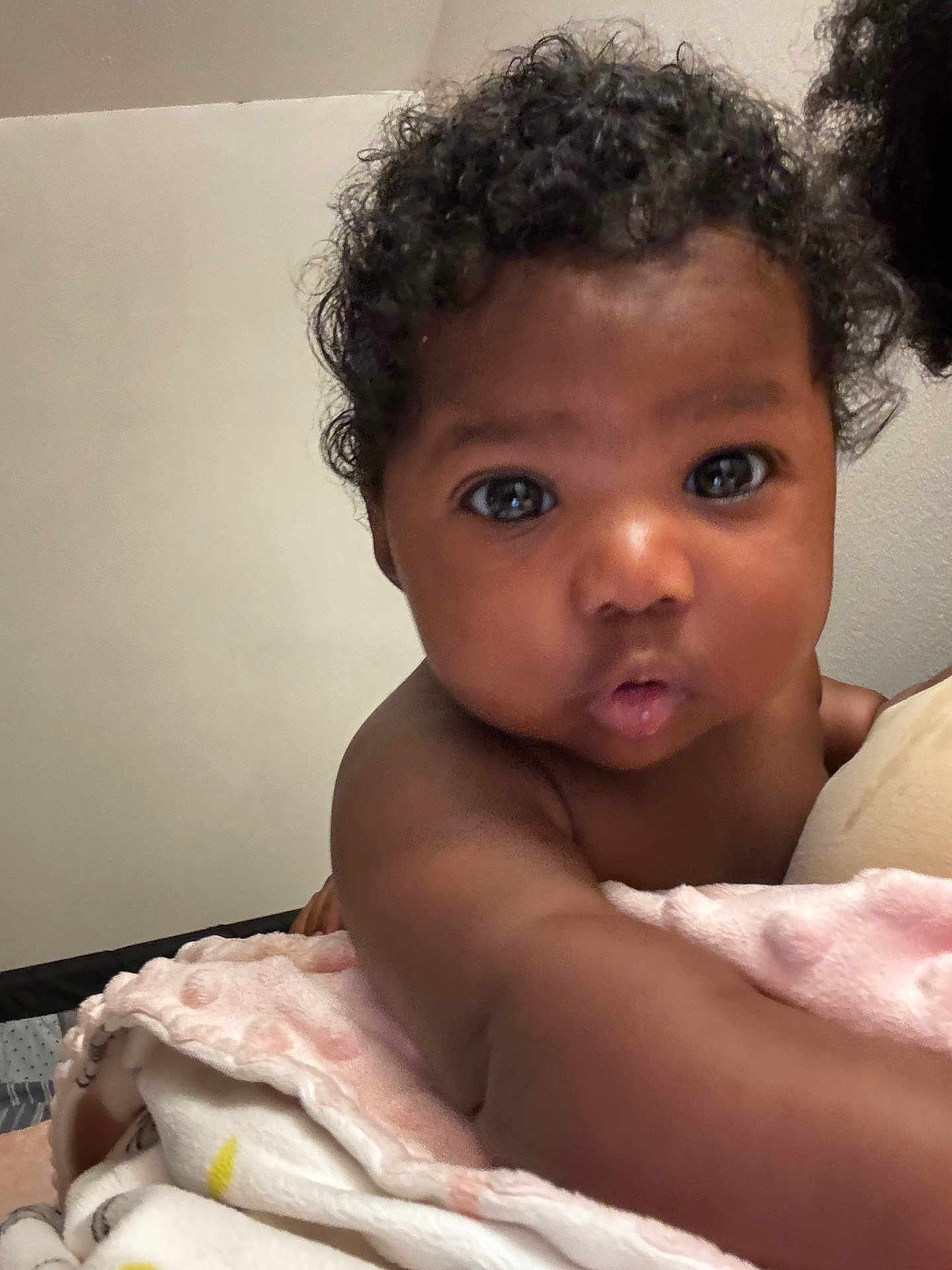 Butterfly joined the competition — help win amazing prizes! baby, infant, curly_hair, blanket, soft_texture, reaching_out, close_up, skin, face, eyes, indoor, child, adorable, cute, expression, portrait, young_child, person, curiosity, toddler