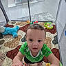 Caius joined the competition — help win amazing prizes! baby, toddler, child, playpen, toy, plush_toy, green_clothing, indoor, floor_mat, quilt, childrens_toy, curly_hair, grip, looking_up, play_area, carpet, trampoline, colorful, person, home