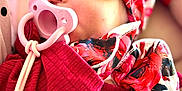Layna is registered to the contest to win money with this photo: baby, sleeping, pacifier, headband, mittens, red_clothing, closeup, infant, cute, peaceful, soft_light, portrait, accessory, fabric, clip, hand, skin, face, newborn, cozy