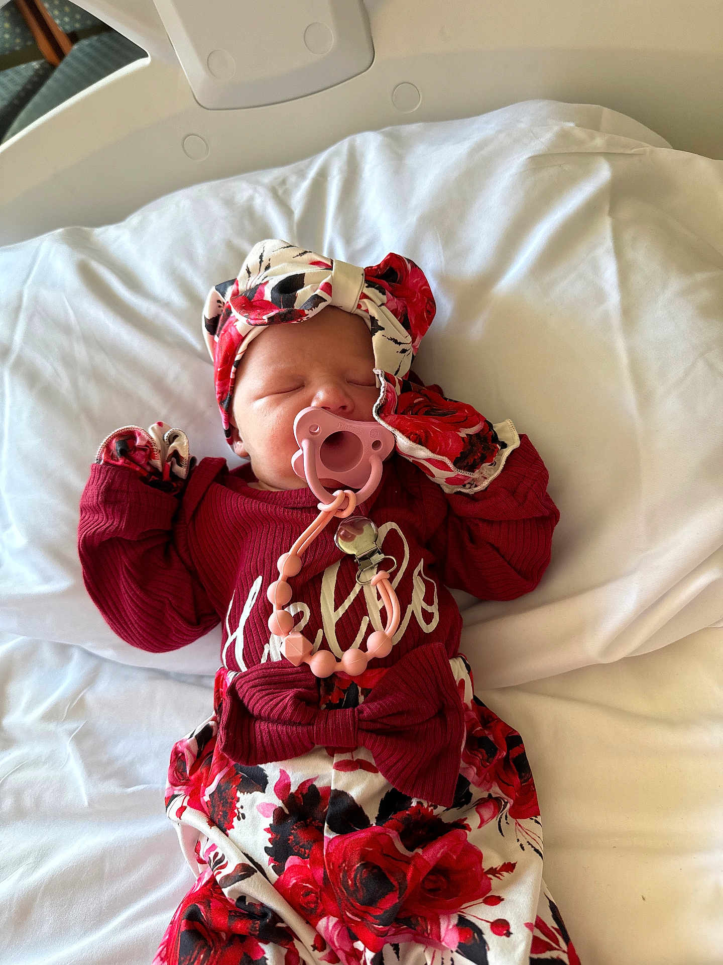 Layna joined the competition — help win amazing prizes! newborn, baby, pacifier, headband, floral_clothing, sleeping, bed, hospital, blanket, infant, cute, child, person, pink, red, white, lying_down, clothing, accessory, sleep