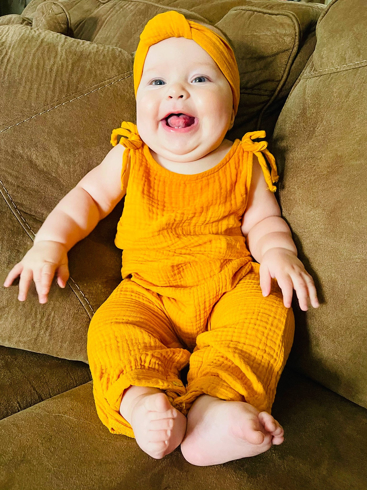 Callie is registered to the contest to win money with this photo: baby, baby_laughing, baby_toddler_clothing, cap, cheek, chin, comfort, costume_hat, eye, face, happy, head, headwear, nose, orange, person, skin, sleeve, smile, t_shirt