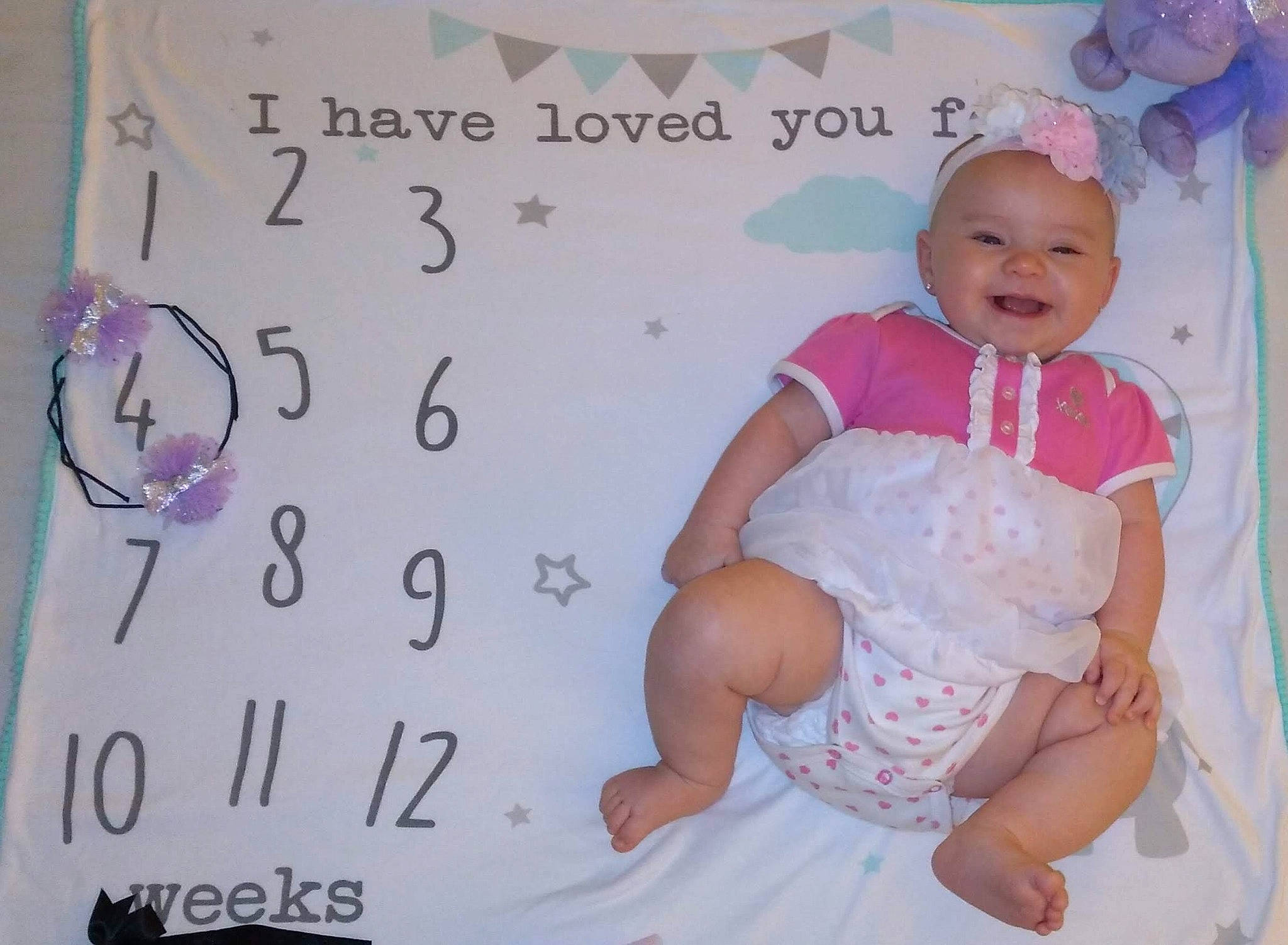 Kayleigh is registered to the contest to win money with this photo: baby, baby_products, baby_toddler_clothing, child, facial_expression, finger, font, happy, headwear, joy, linens, magenta, pattern, peach, person, pink, purple, room, sitting, sleeve