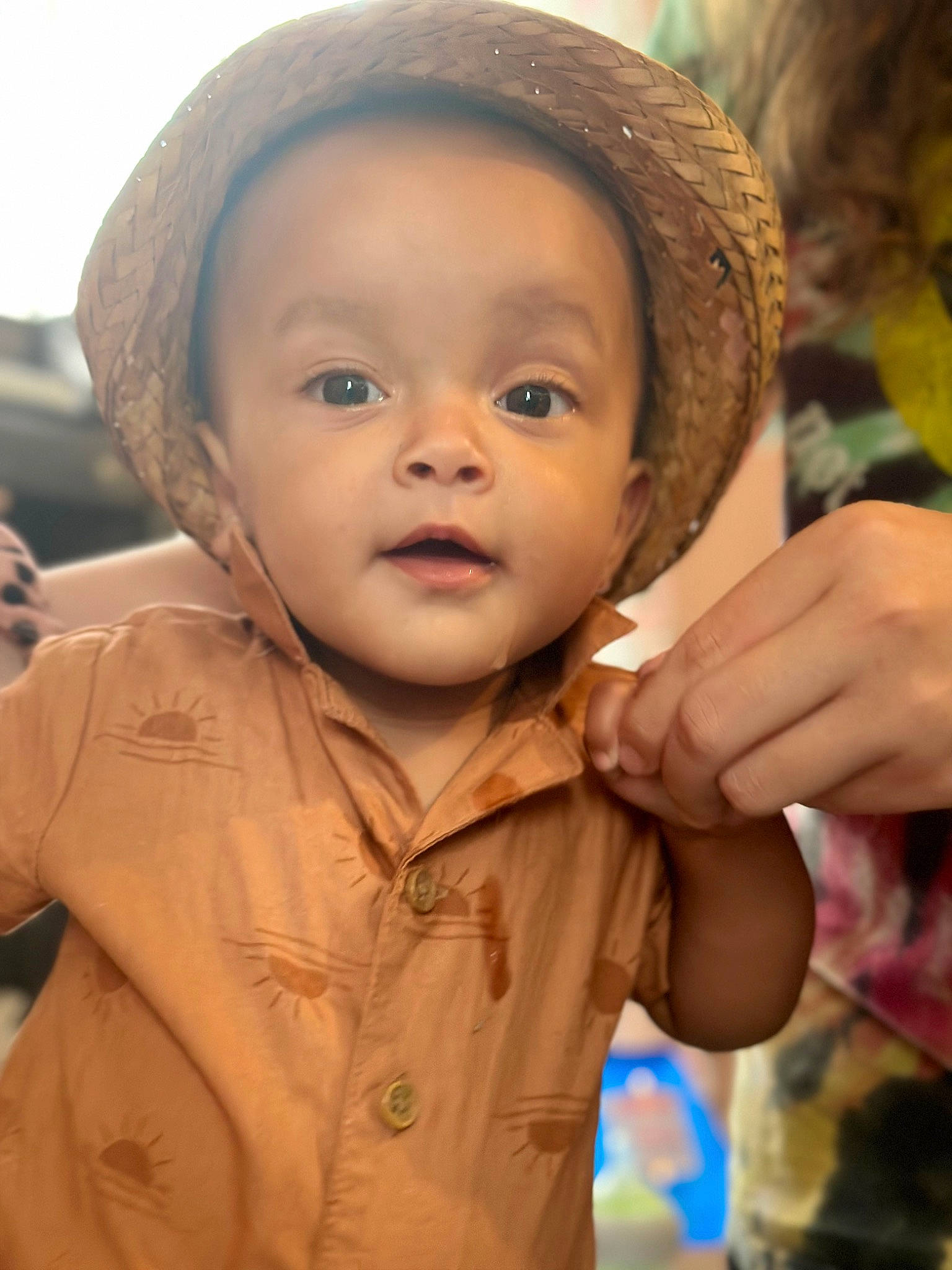 Riley is registered to the contest to win money with this photo: baby, cheek, child, facial_expression, fashion_accessory, finger, fun, gesture, happy, hat, headgear, lip, nose, people_in_nature, person, skin, sleeve, sun_hat, thumb, toddler