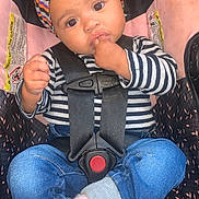 Royal joined the competition — help win amazing prizes! baby, child, car_seat, headband, striped_shirt, jeans, socks, sitting, hands, face, eyes, black_hair, curly_hair, safety_harness, infant, cute, indoor, young_child, portrait, clothing