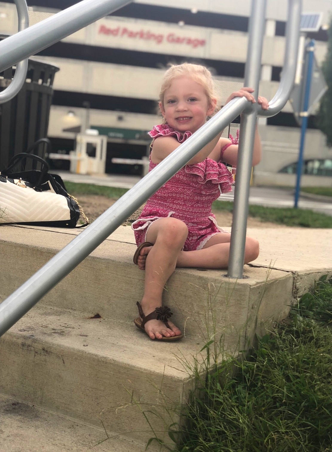 Elayna is registered to the contest to win money with this photo: blond, child, daughter, fun, grass, handrail, joy, leg, person, pink, plant, play, playground, public_space, recreation, sitting, smile, summer, toddler, tree