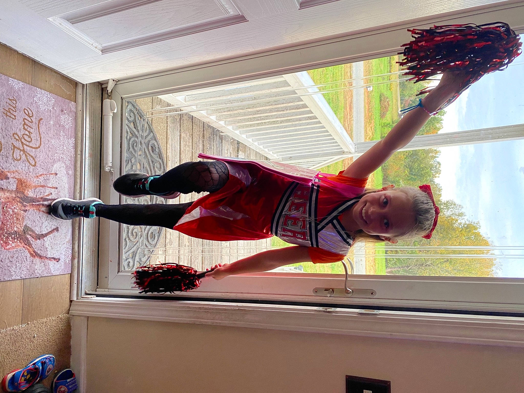 Samantha is registered to the contest to win money with this photo: balance, ceiling, elbow, flooring, fun, happy, joy, lighting, line, magenta, molding, person, plant, red, room, shorts, smile, sportswear, tree, twig