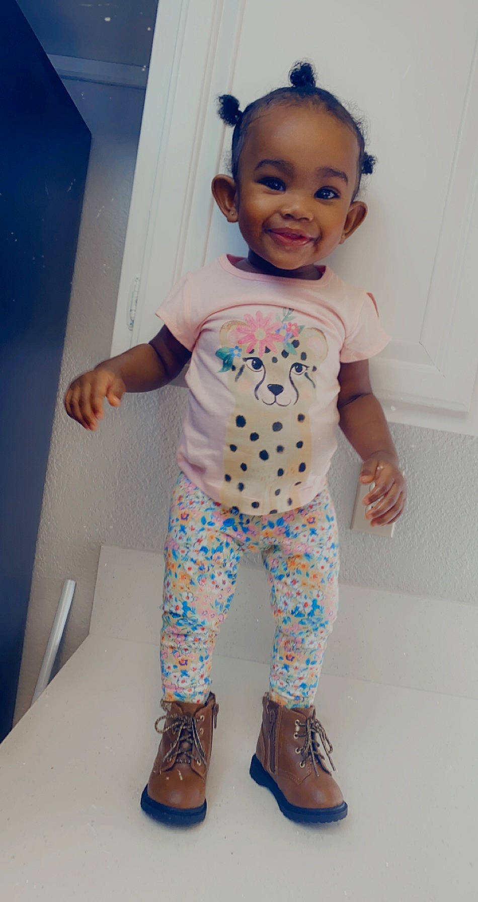 Amora is registered to the contest to win money with this photo: baby, baby_toddler_clothing, blue, cheek, child, footwear, head, joy, leggings, pajamas, pattern, person, shoe, skin, sleeve, smile, standing, t_shirt, toddler, yellow