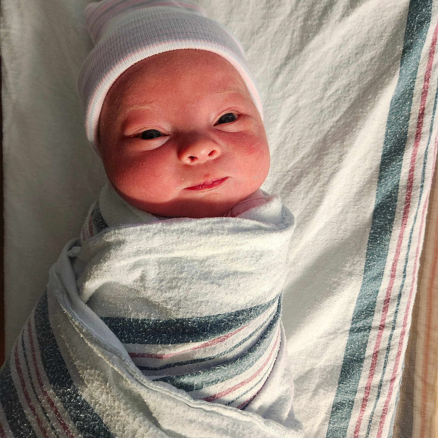 Oliviajane joined the competition — help win amazing prizes! baby, blanket, child, cute, eyes_open, face, fresh, hat, hospital, indoors, infant, lying_down, newborn, portrait, skin, smile, soft_light, striped_blanket, swaddle, wrapped