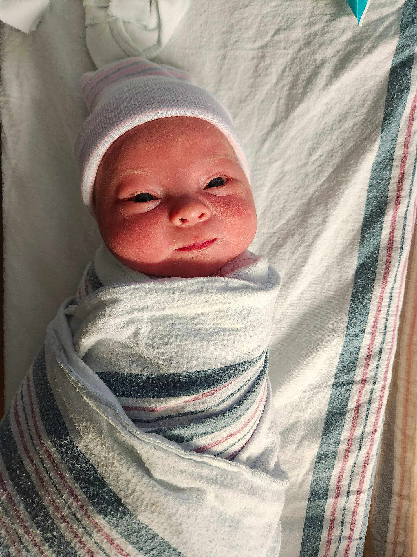 Oliviajane joined the competition — help win amazing prizes! newborn, baby, infant, wrapped, blanket, striped_blanket, hat, cute, face, lying_down, hospital, fresh, skin, eyes_open, smile, soft_light, portrait, child, swaddle, indoors