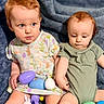 baby, toddler, child, red_hair, easter_eggs, plastic_eggs, dress, onesie, blue_blanket, indoor, sitting, cute, playing, toy, two_children, person, face, happy, curious, soft_lighting