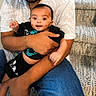 Niyansh joined the competition — help win amazing prizes! baby, child, person, adult, arms, holding, smile, happy, indoor, carpet, stairs, blue_jeans, shirt, patterned_shirt, skin, face, hands, sitting, casual_clothing, family