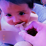Kasiah is registered to the contest to win money with this photo: baby, chewing, child, closeup, curious, cute, expression, face, feeding, hand, head, highchair, indoor, infant, person, plastic, portrait, skin, toy, young_child