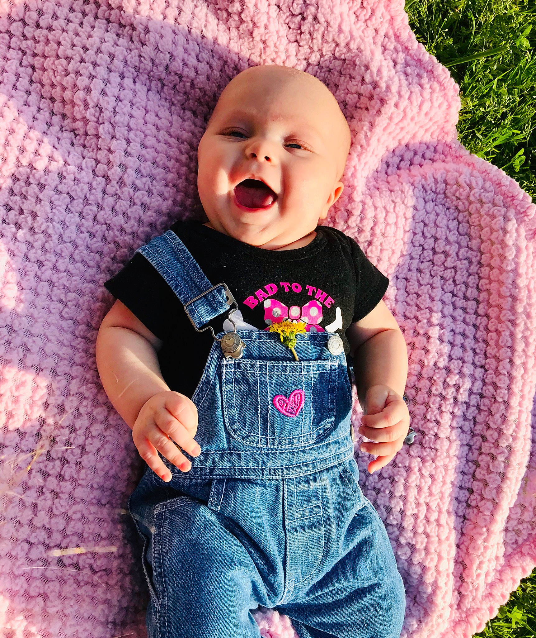 Carter Mae joined the competition — help win amazing prizes! baby, baby_products, baby_toddler_clothing, cheek, child, cool, design, face, facial_expression, grass, head, jeans, overall, person, pink, product, purple, skin, smile, textile