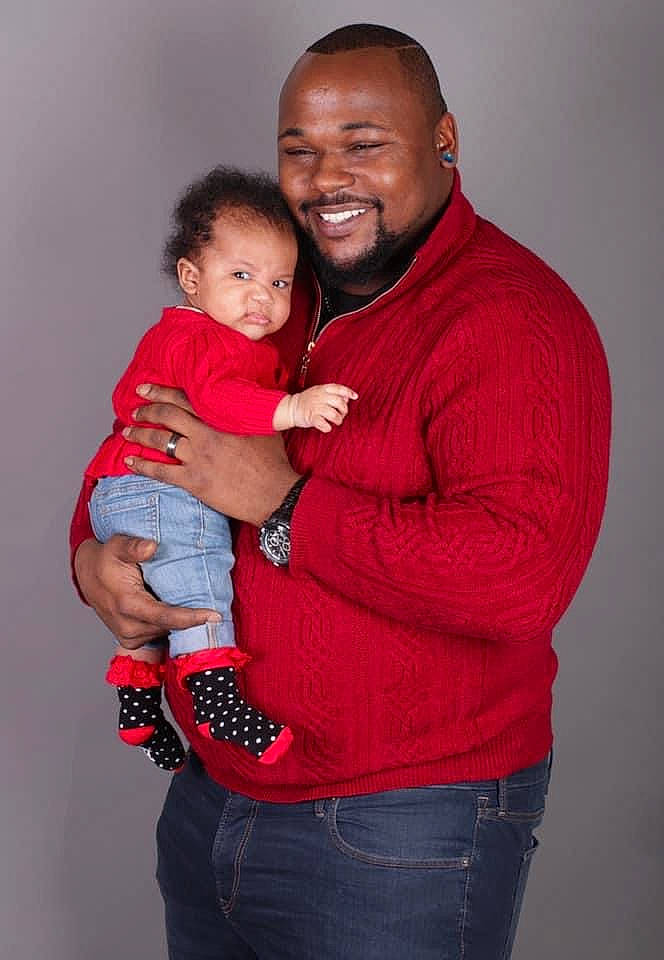 Arizona is registered to the contest to win money with this photo: arm, baby_toddler_clothing, carmine, cheek, denim, elbow, finger, hand, interaction, jeans, joint, joy, love, muscle, person, product, red, shoulder, sleeve, standing