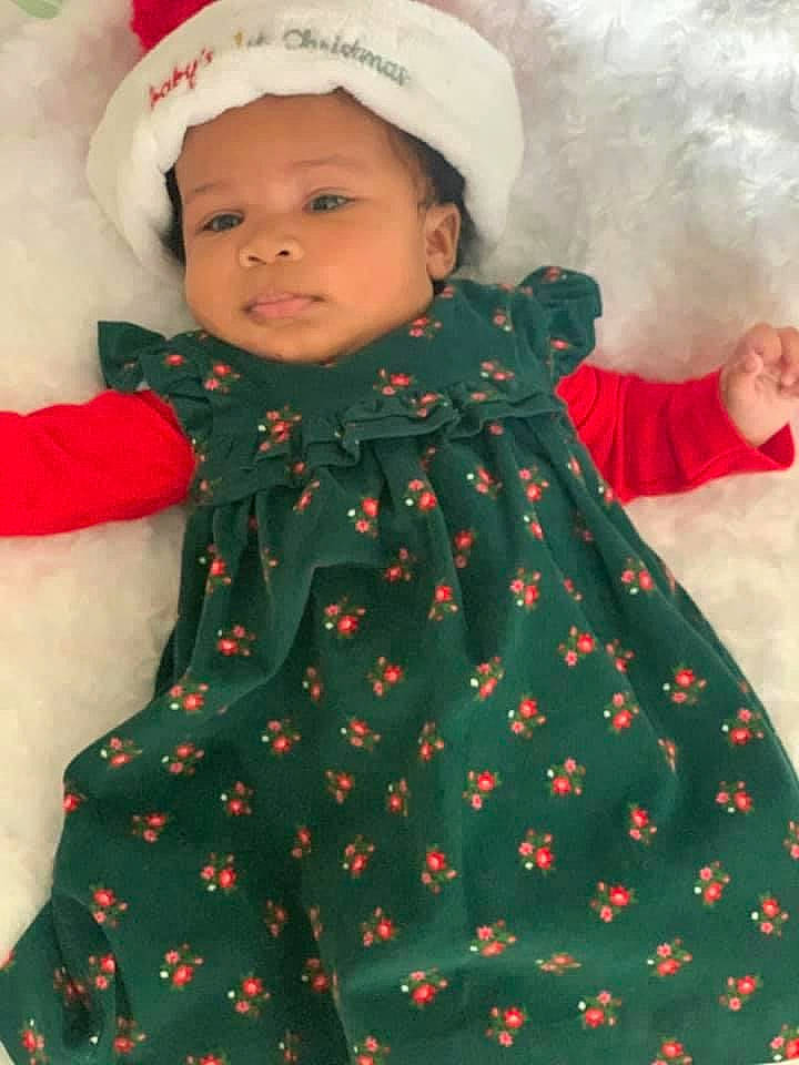 Arizona is registered to the contest to win money with this photo: baby_toddler_clothing, cheek, child, clothing, costume_accessory, dress, eye, face, fur, headgear, headwear, lip, nose, one_piece_garment, pattern, person, red, skin, sleeve, textile