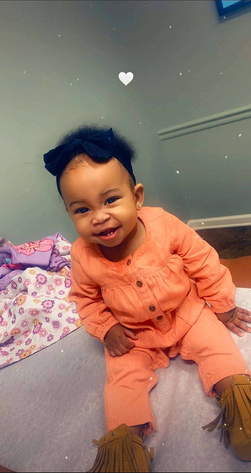 Kylah joined the competition — help win amazing prizes! baby, baby_toddler_clothing, cheek, child, comfort, dress, flooring, fun, gesture, happy, human_body, joy, nose, person, play, room, sitting, skin, sleeve, smile