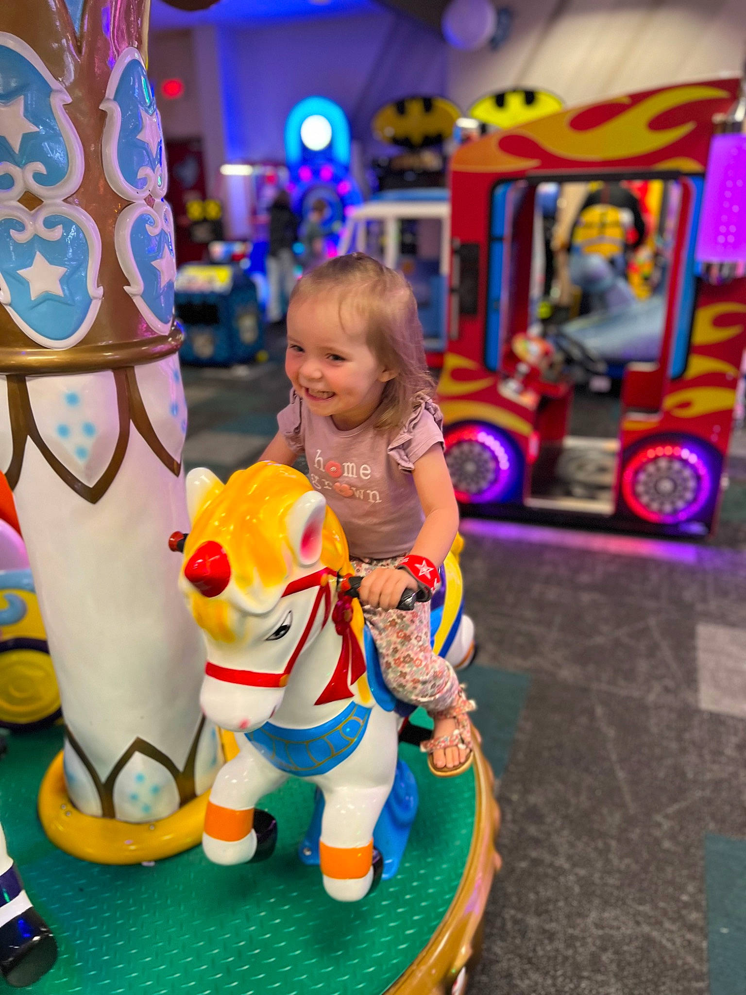 Lilyth is registered to the contest to win money with this photo: amusement_ride, carousel, child, entertainment, fun, happy, horse, joy, leisure, people, person, photograph, public_space, recreation, riding_toy, smile, tire, toddler, toy, wheel