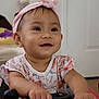 baby, child, smiling, headband, indoor, toy_car, hands, face, cute, happy, clothing, short_sleeves, pink, skin, earrings, person, infant, playtime, expression, young