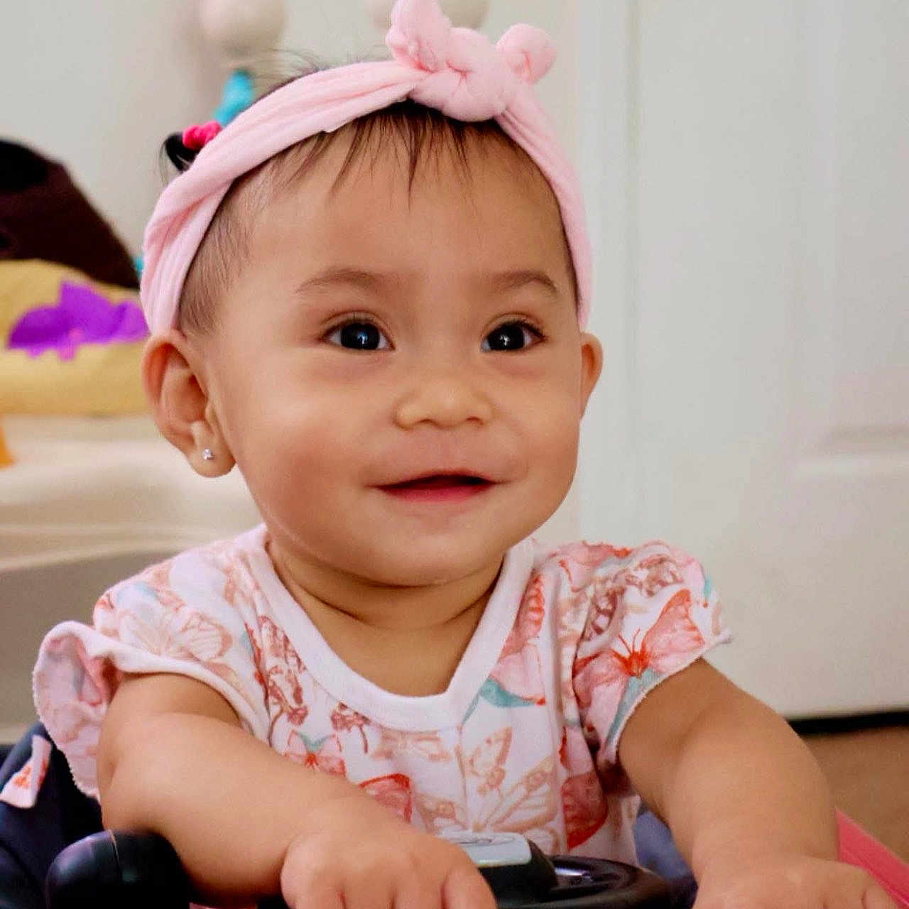 Felizia Rae joined the competition — help win amazing prizes! baby, child, clothing, cute, eyes, face, hands, happy, headband, home, indoor, infant, person, pink, playing, portrait, smile, toddler, toy_car, young_child