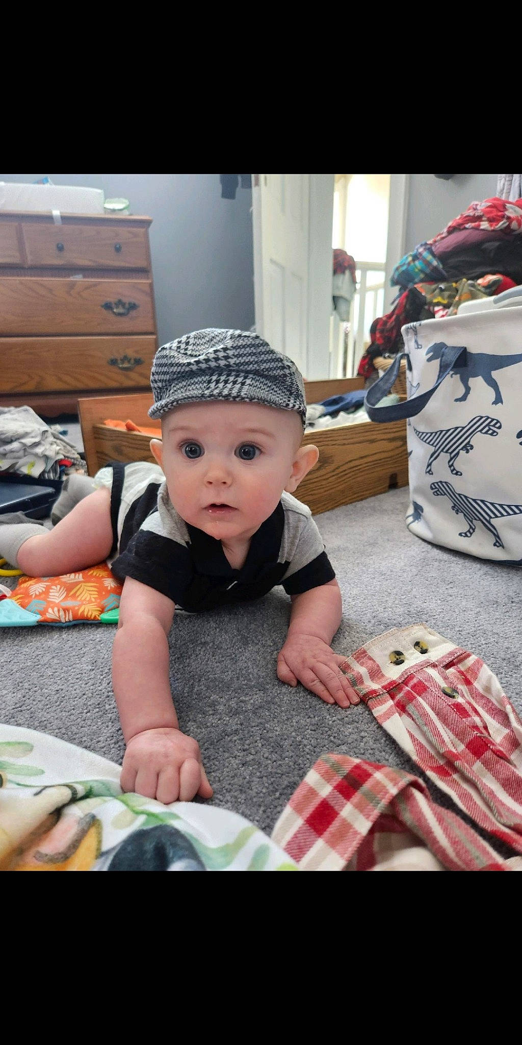 Wylee is registered to the contest to win money with this photo: baby, baby_toddler_clothing, cabinetry, cap, child, fashion_accessory, flooring, happy, hat, headgear, headwear, pattern, person, photograph, plaid, room, sitting, sleeve, sun_hat, surprise