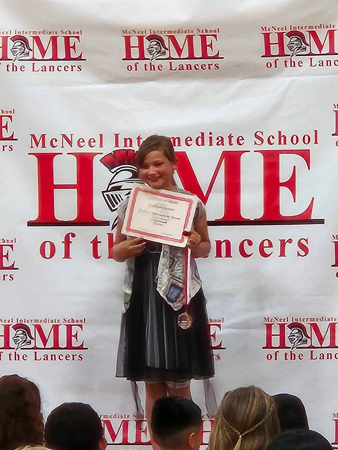 Kaitlyn is registered to the contest to win money with this photo: advertising, competition, costume, crowd, event, fashion_design, font, job, joy, microphone, orator, outerwear, person, public_event, public_speaking, sleeve, smile, speech, spokesperson, stage_equipment