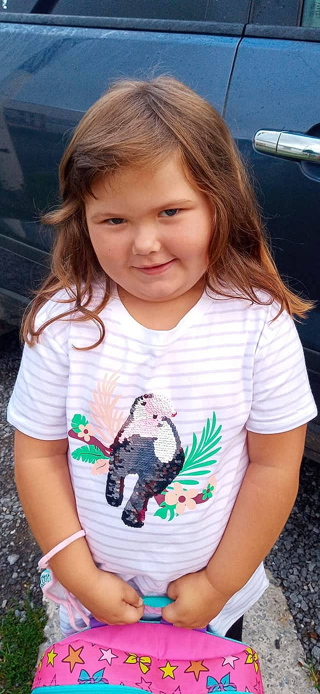 Evelyn is registered to the contest to win money with this photo: arm, baby_toddler_clothing, cheek, eye, face, hair, hairstyle, happy, iris, joy, mouth, neck, organ, person, pink, product, shoulder, skin, sleeve, t_shirt