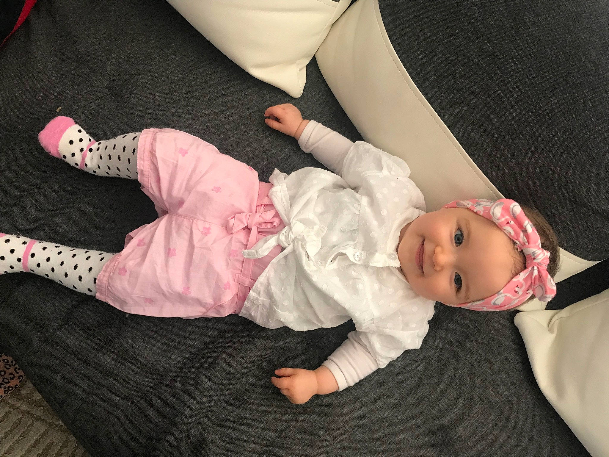 Celyanna participe au concours pour gagner de l'argent avec cette photo : arm, baby, baby_toddler_clothing, child, comfort, finger, hand, hat, headwear, human_body, human_leg, joy, knee, lap, leg, person, pink, skin, sleeve, sock