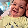 Antonio is registered to the contest to win money with this photo: child, toddler, smiling, face, indoor, window, shirt, anchor, text, closeup, person, happy, cute, baby, portrait, clothing, head, young, dimple, light