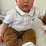 Alessio participe au concours pour gagner de l'argent avec cette photo : baby, child, infant, polo_shirt, corduroy_pants, white_shoes, soft_mat, indoors, portrait, cute, sitting, curious, chubby_cheeks, big_eyes, casual_clothing, white_background, comfortable, young_child, close_up, innocent_expression