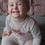 Célina a rejoint le concours — aidez-le/la à gagner de superbes lots ! blanket, child, comfort, cozy, cushion, cute, face, furniture, happy, home, indoor, pajamas, person, playful, portrait, seated, smiling, sofa, toddler, young_child