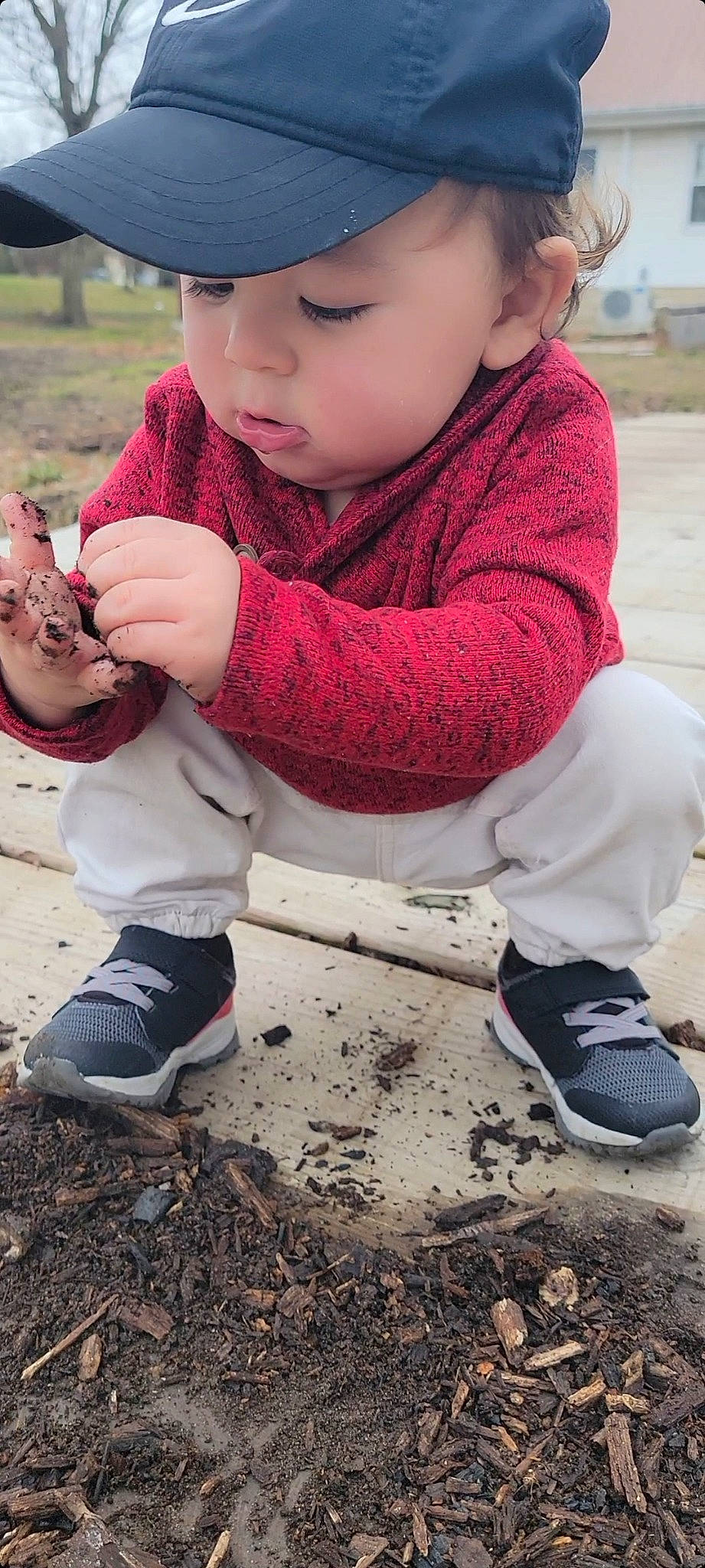 Liam is registered to the contest to win money with this photo: baby, baby_toddler_clothing, blue, cap, child, fun, grass, hand, headwear, human_leg, leisure, pattern, person, play, recreation, sitting, sleeve, sneakers, soil, t_shirt