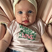 Thays a rejoint le concours — aidez-le/la à gagner de superbes lots ! baby, infant, headband, bow, pink_shirt, clover, love_text, blue_eyes, denim_pants, soft_cushion, seated, cute, adorable, portrait, child, clothing, face, expression, curious, indoor