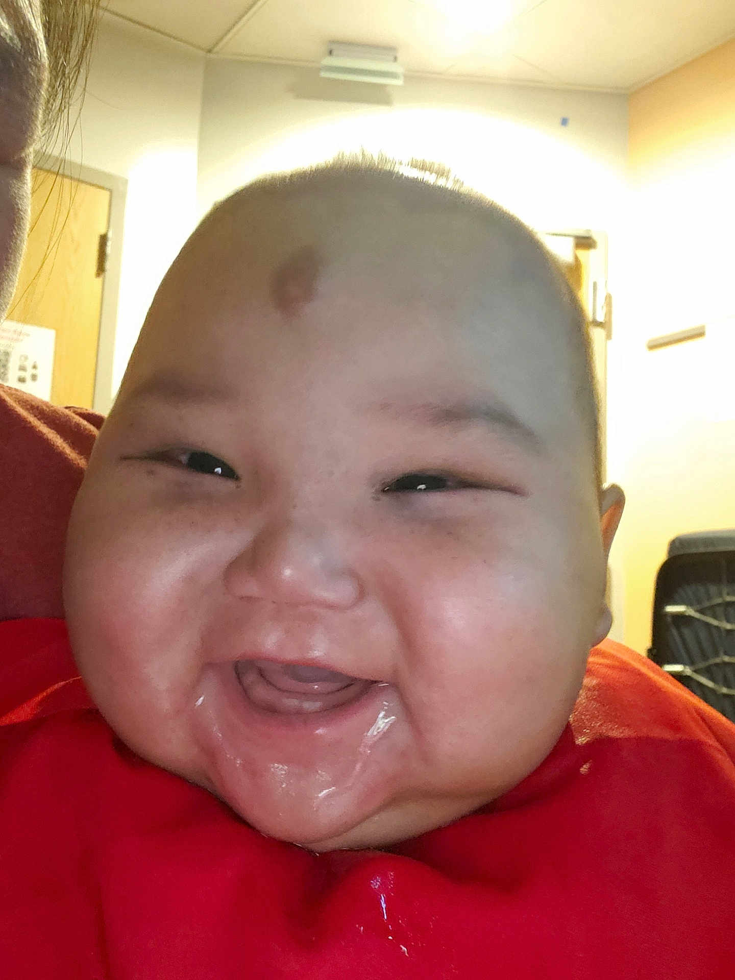 Nicholas joined the competition — help win amazing prizes! baby, smiling, close_up, face, infant, red_clothing, indoors, joyful, drool, cheeks, person, child, head, happy, expression, skin, mouth, eyes, room, light